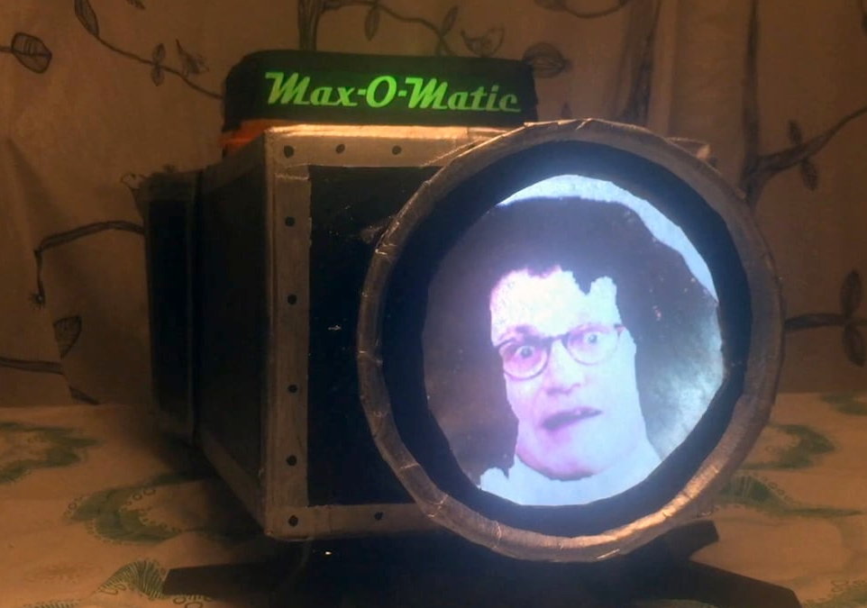 A prop slide projector made out of cardboard, a flower pot, and parchment paper.